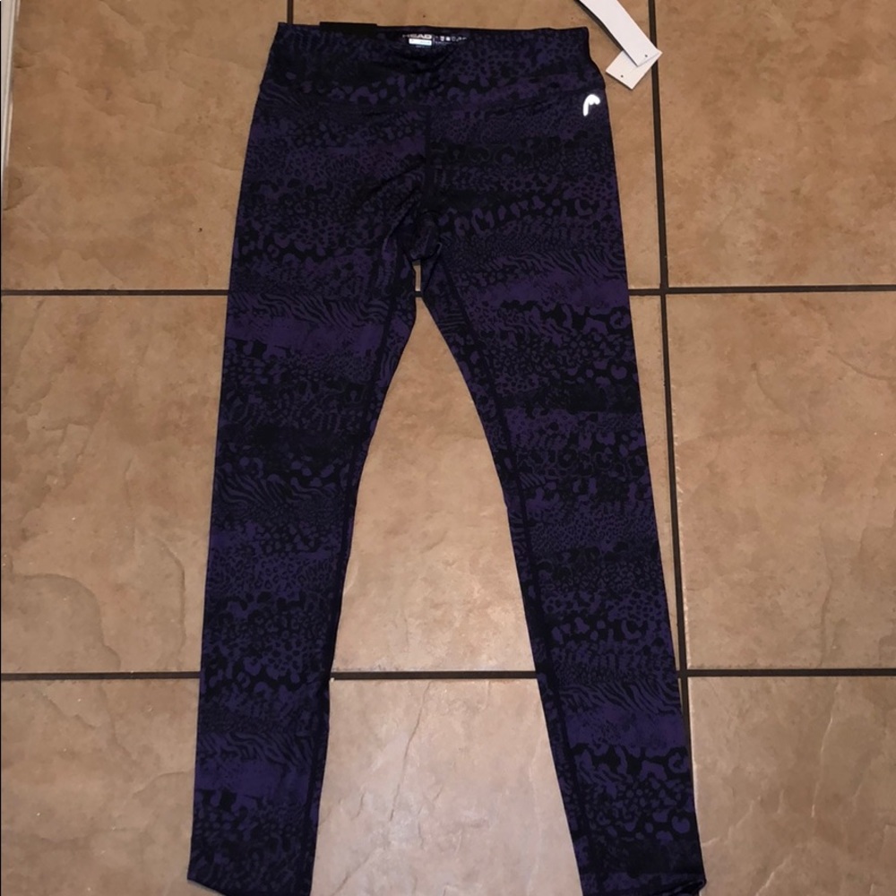 Tight fitted purple leggings. Brand Head.